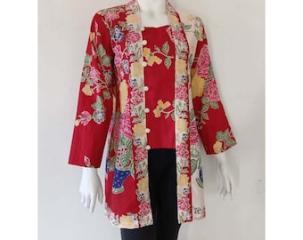 May include: Red and white patterned long-sleeved top with a button-up front and a matching inner top. The top has a floral and geometric design.