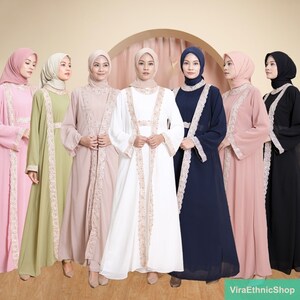 May include: Seven women wearing long, flowing abayas with lace trim. The abayas are in various colors, including pink, green, beige, white, navy blue, and black. The women are wearing matching headscarves.