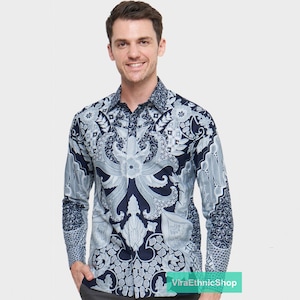 May include: A long-sleeved shirt with a navy blue background and a white paisley pattern. The shirt has a button-up collar and a button closure.