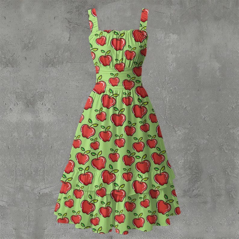 May include: A green sundress with a red apple pattern. The dress features a fitted bodice, thin straps, and a flared skirt with a ruffled hem. The apple design includes red apples with green leaves, creating a playful and summery look.