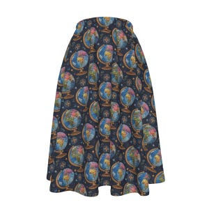 May include: A flared skirt featuring a repeating pattern of vintage-style globes on stands and small compass roses against a dark navy blue background. The globes display colorful continents in shades of yellow, green, and pink with blue oceans.