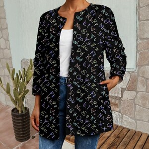 May include: Black open-front jacket with a colorful letter pattern. The jacket has long sleeves, pockets, and a collarless design. The letters are in various colors, creating a vibrant and eye-catching look. This jacket is a stylish addition to any wardrobe.