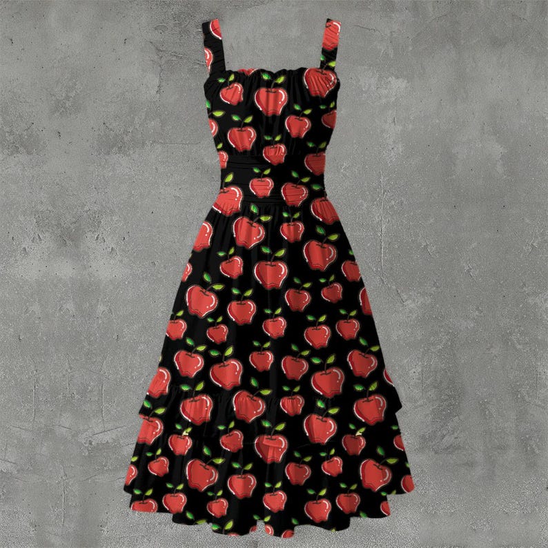 May include: A black sundress with a red apple pattern. The dress has a fitted bodice, spaghetti straps, and a tiered skirt. The apples have green leaves and are scattered across the fabric.