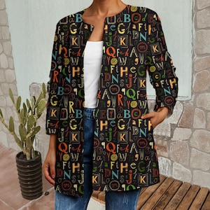 May include: A black duster coat with a colorful alphabet pattern. The coat features a collarless design, long sleeves, and pockets. The letters are in various colors, including orange, green, and blue.