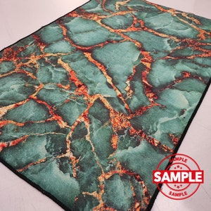May include: Green and orange marble patterned rug with a black border. The rug has a "SAMPLE" label in the bottom right corner.
