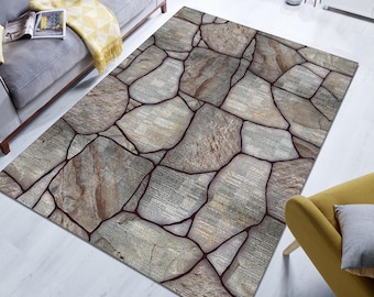 May include: A gray and brown area rug with a stone pattern. The rug has a dark brown border and is made of a soft, plush material.
