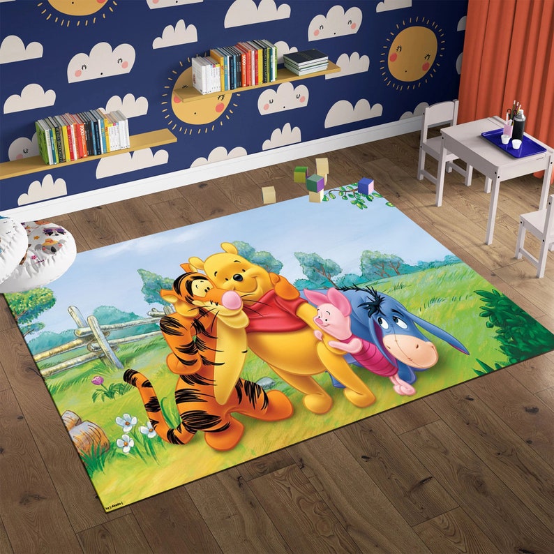 May include: A Winnie the Pooh themed rug featuring Winnie the Pooh, Tigger, Piglet, and Eeyore. The rug is a light blue color with green grass and flowers. The characters are smiling and hugging each other.