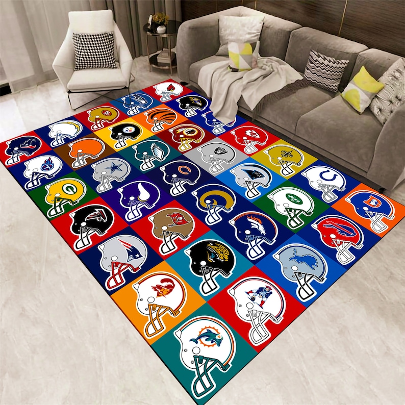 May include: A colorful area rug featuring a grid pattern of American football helmets. Each helmet is set against a vibrant square background, showcasing various team logos and colors. The rug is designed for indoor use.
