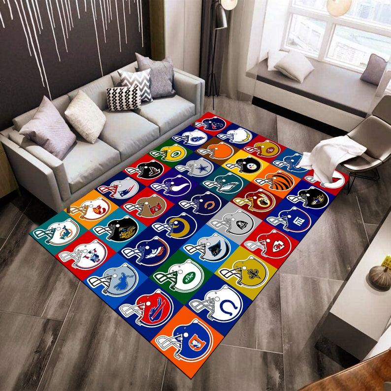May include: A rectangular area rug featuring a grid of colorful squares, each displaying a different American football helmet design. The rug's design includes a variety of team logos in vibrant colors, set against a neutral background.