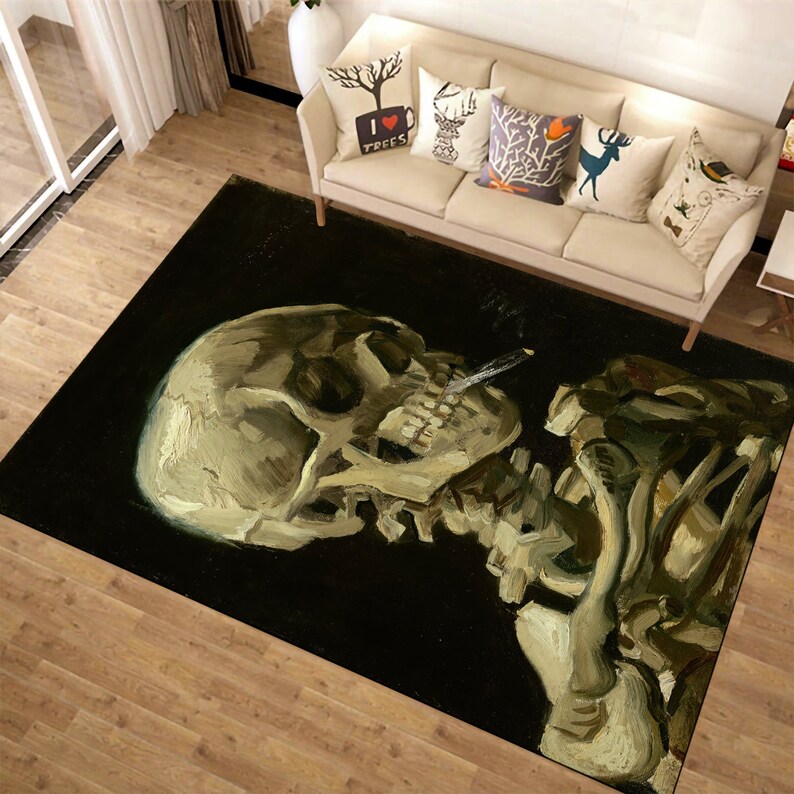 May include: A black and white rug with a painting of a skull and skeleton. The skull is facing to the left and has a cigarette in its mouth. The skeleton is holding its arm up in the air.