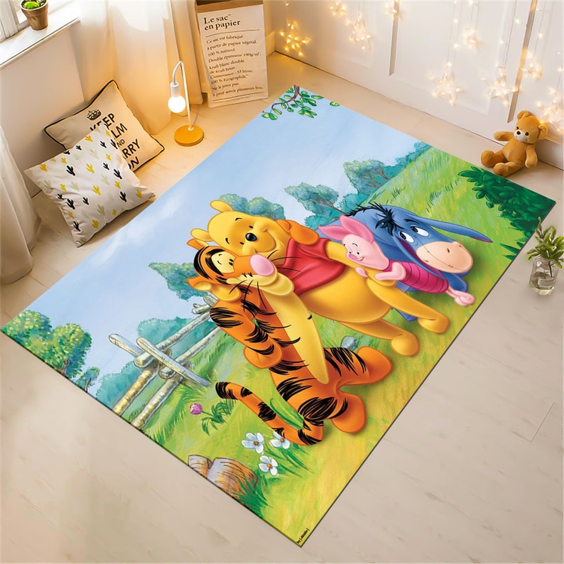 May include: A colorful cartoon rug featuring Winnie the Pooh, Tigger, Piglet, and Eeyore. The rug has a light blue background with green grass and trees.