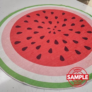 May include: A round watermelon-shaped rug with a green, white and pink border. The watermelon has black seeds and the text "SAMPLE" is printed on a white circle in the bottom right corner.