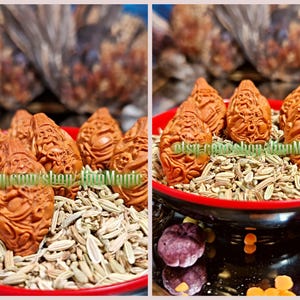 May include: A collection of reddish-brown, intricately carved figurines, possibly decorative items, displayed in a red bowl filled with seeds. The background is blurred, with hints of other objects. The figurines are the focal point.