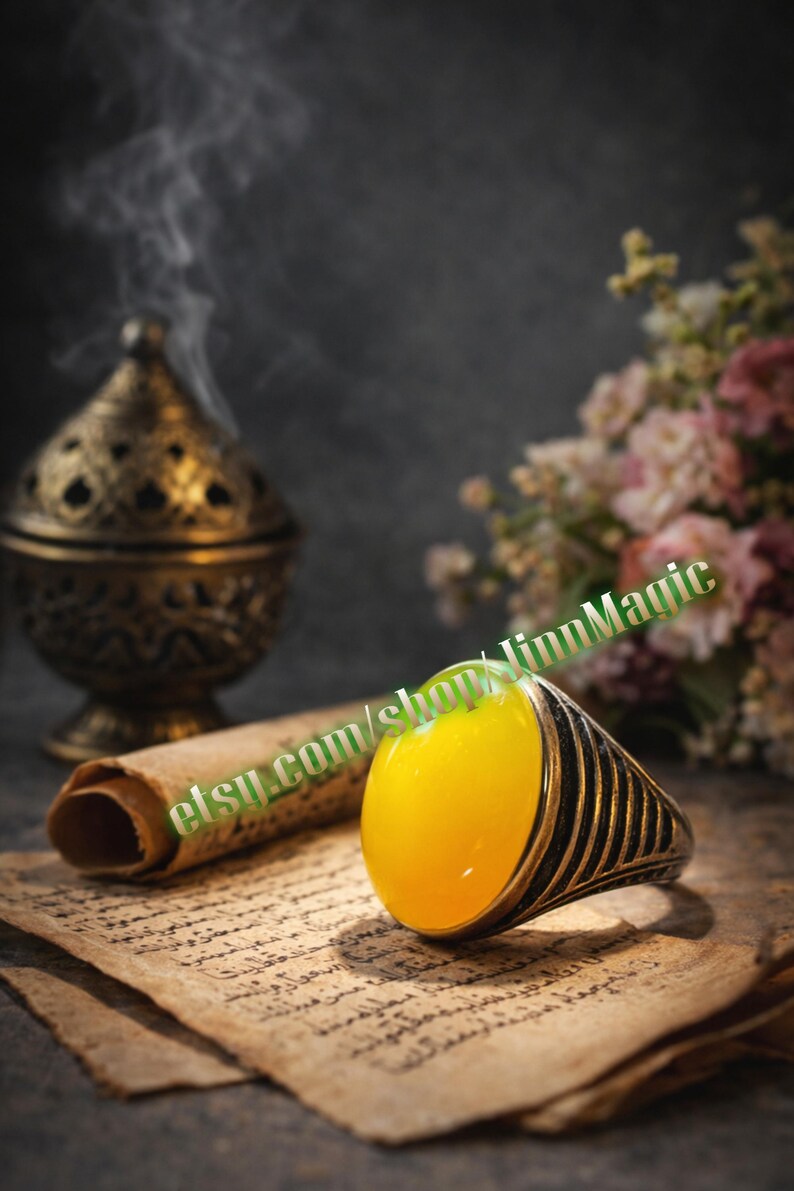 May include: A silver ring with a large, oval, yellow gemstone. The ring has a black striped design on the band. The image also includes a decorative incense burner, a scroll, and flowers. The text "etsy.com/shop/linnMagic" is visible.