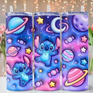 May include: Three stainless steel tumblers with a space-themed design featuring the character Stitch. The tumblers have a blue, pink, and purple gradient background with planets, stars, and candy. Each tumbler has a straw.