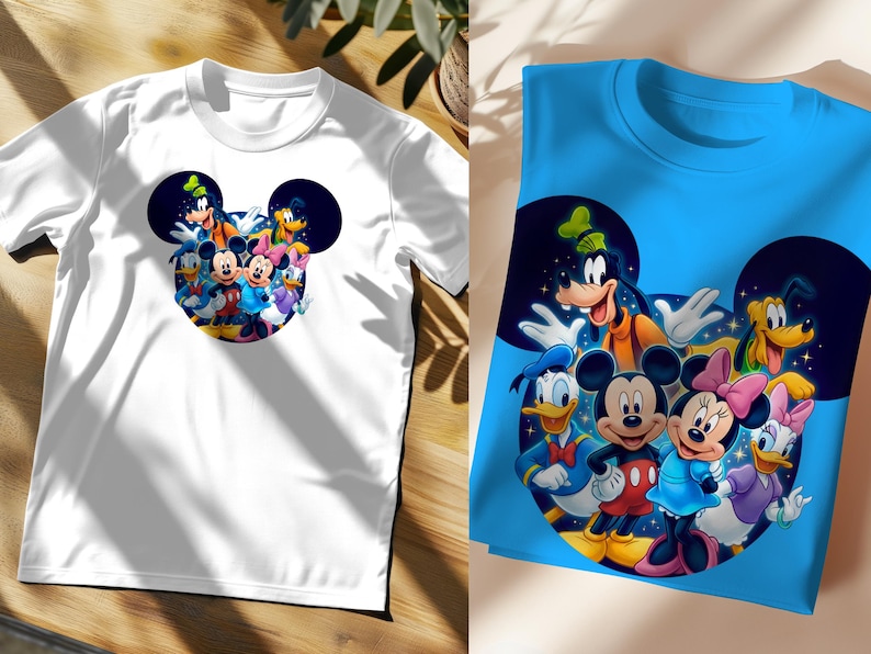May include: White t-shirt featuring a colorful graphic of Mickey Mouse and friends inside a Mickey Mouse head shape. The design includes characters like Mickey, Minnie, Donald Duck, and Goofy. A second blue t-shirt with the same design is also shown.
