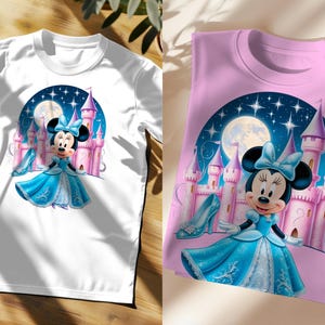 May include: Two t-shirts featuring a cartoon image of Minnie Mouse dressed as a princess in front of a pink castle. The image is set against a blue night sky with stars and a moon. One t-shirt is white and the other is pink.
