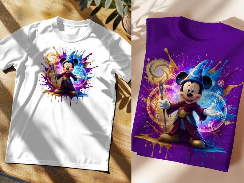 May include: White and purple t-shirts featuring a cartoon illustration of Mickey Mouse dressed as a wizard. The design includes colourful paint splatters, a magic staff, and mystical symbols. The shirts are short-sleeved.
