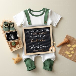 May include: A black letter board with white letters announcing the arrival of a baby. The text reads "We finally reached the pot of gold at the end of our rainbow. Baby O'Connor March 2024".