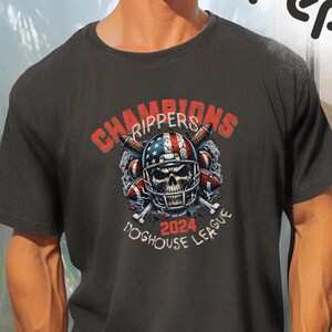 May include: Black t-shirt with a graphic of a skull wearing a football helmet with an American flag design. The text "Champions Rippers 2024 Doghouse League" is printed on the shirt.