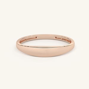 May include: A simple, polished rose gold band ring with a rounded, slightly curved shape.