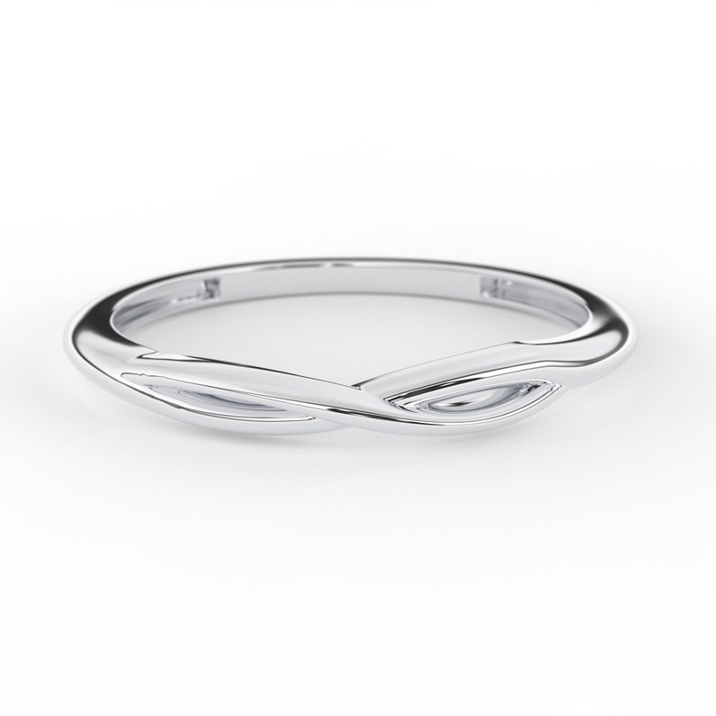 May include: A silver ring with a twisted design. The ring is smooth and polished.