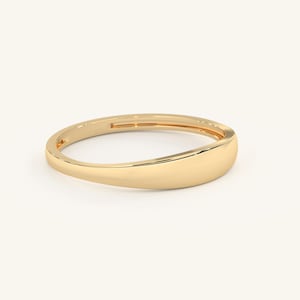 May include: A simple gold band ring with a rounded, slightly curved top. The ring is smooth and polished.
