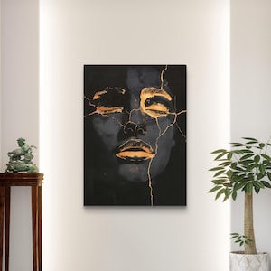 May include: A rectangular wall art print featuring a dark, monochromatic portrait of a face with closed eyes and lips highlighted in metallic gold. The image displays a cracked, kintsugi-inspired aesthetic with thin gold lines running across the skin.