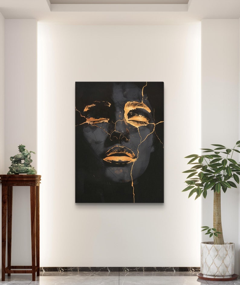 May include: A rectangular wall art print featuring a dark, monochromatic portrait of a face with closed eyes and lips highlighted in metallic gold. The image displays a cracked, kintsugi-inspired aesthetic with thin gold lines running across the skin.