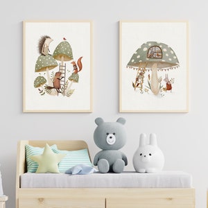 May include: Two framed illustrations of woodland creatures in a mushroom forest. The first illustration shows a hedgehog, squirrel, and a beaver climbing a ladder. The second illustration shows a rabbit and a deer looking at a mushroom house.