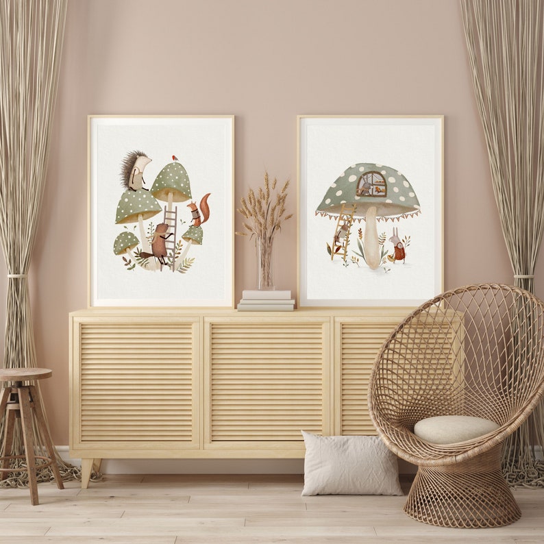 May include: Two framed illustrations of mushrooms with animal characters. The first illustration features a hedgehog, a squirrel, and a bird on a mushroom with a ladder. The second illustration features a bunny and a bird on a mushroom with a window.