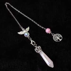 May include: A silver chain with a pink crystal bead, a silver tree of life charm, and a white crystal pendulum with a silver crown and angel wings.
