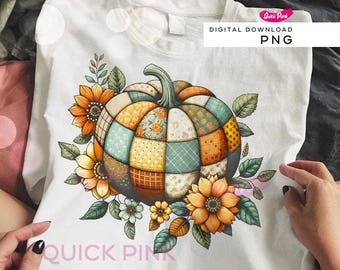May include: White t-shirt featuring a colorful patchwork pumpkin design surrounded by sunflowers and leaves. The pumpkin has a green stem and is made of various patterned fabric squares. The design includes the text "DIGITAL DOWNLOAD PNG".