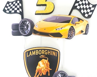 May include: A yellow Lamborghini car cake topper with the name "NATHANIEL" and the number "5" in gold. Includes checkered flags, tires, and a Lamborghini emblem. A fun decoration for a car-themed birthday party.