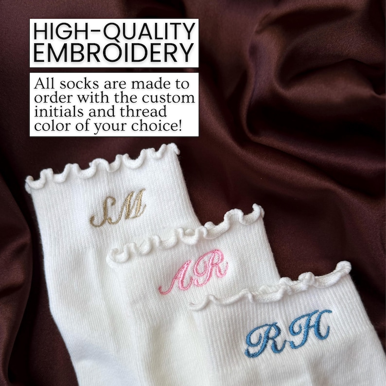 Personalized white ruffle socks with embroidered initials photographed on silky satin background featuring aesthetic custom pilates socks designed for women who love barre classes yoga outfits and trendy minimalist accessories with elegant pastel thread embroidery and feminine boutique inspired details making these socks perfect for bridesmaid gifts bridal party favors birthday presents college girl gifts self care baskets holiday gifts and cozy lounge wear fashion accessories