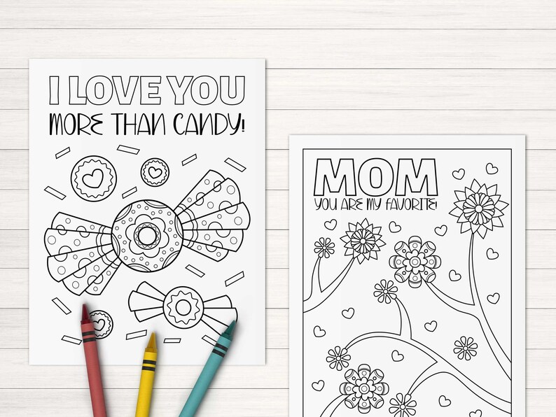 May include: Two black and white coloring pages. The first page features a candy with the text "I love you more than candy!" The second page features flowers and the text "Mom you are my favorite".