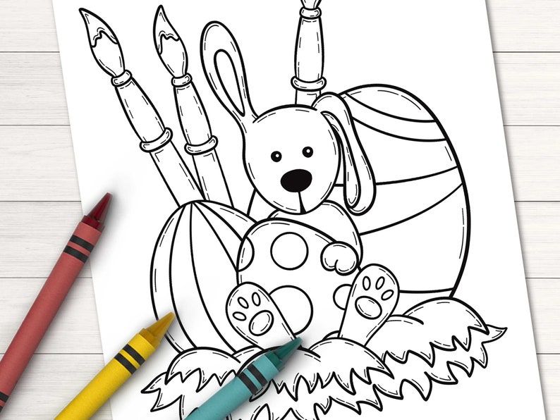 Puede incluir: Un dibujo en blanco y negro de un conejo sosteniendo un huevo de Pascua. El conejo est&aacute; sentado en un nido de hierba con tres pinceles detr&aacute;s.