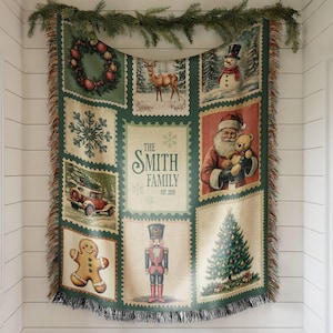 May include: A woven Christmas throw blanket with a green border and fringe. The blanket displays festive images such as a wreath, deer, snowman, snowflake, Santa Claus, gingerbread man, nutcracker, and Christmas tree. The text "THE SMITH FAMILY EST. 2025" is also present.