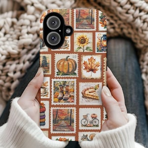 May include: A phone case featuring a collage of autumn-themed postage stamp designs. The stamps depict pumpkins, sunflowers, fall foliage, and forest scenes in warm, earthy tones. The case is held by a person wearing a white sweater.