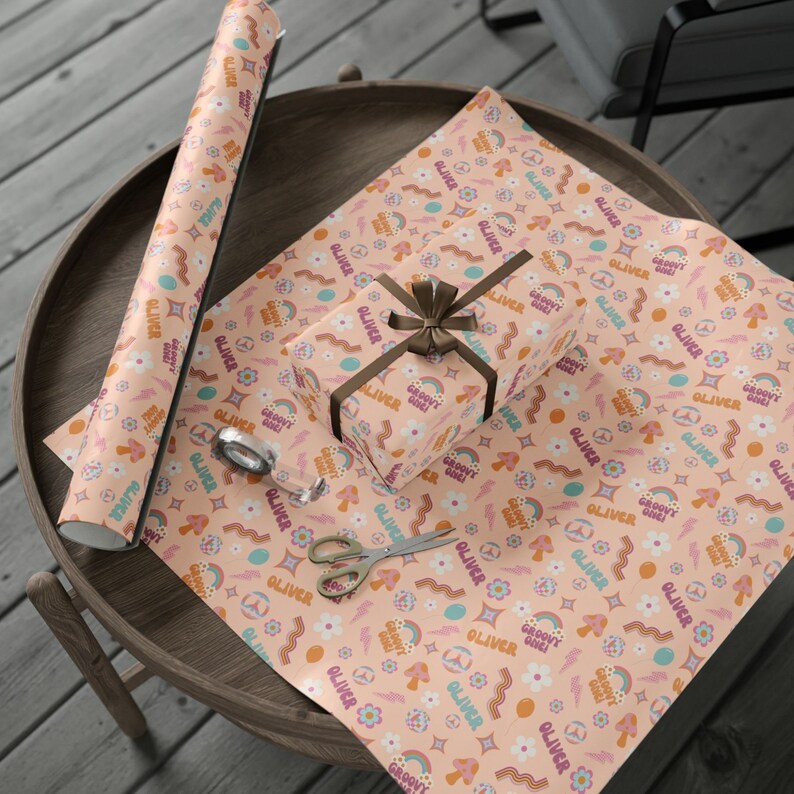 May include: A peach-colored wrapping paper with a repeating pattern of rainbows, flowers, mushrooms, and the text "Oliver Groovy Dude!"