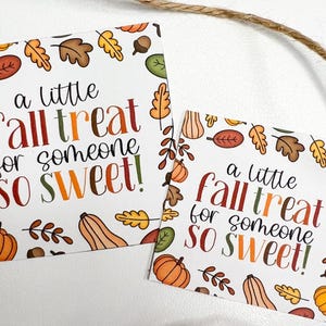 May include: Two white cards with fall-themed illustrations and text. The cards feature pumpkins, leaves, and acorns around the edges. The text reads "a little fall treat for someone so sweet!" in colorful lettering.