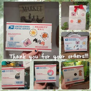 May include: Five white Priority Mail boxes with different stickers on them. The boxes are all different sizes and have the United States Postal Service logo on them. The stickers are all different designs and include a bunny, a dog, a cat, and a camera.