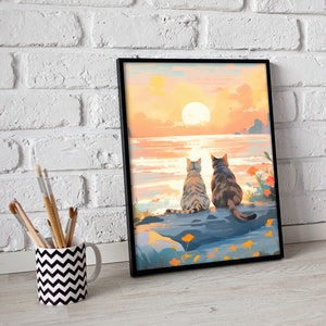 May include: Two cats sit side-by-side on a rock overlooking a body of water with a large orange sun setting in the distance. The sky is a gradient of orange, pink, and yellow.