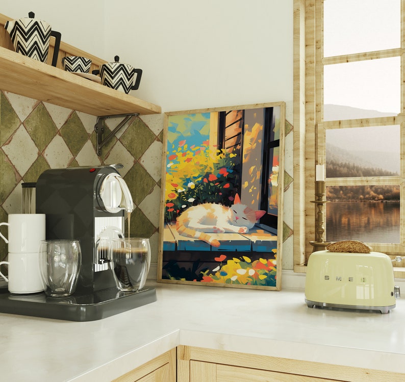 May include: A white cat with orange markings is sleeping on a windowsill in a colourful painting. The painting is framed and hanging on a wall in a kitchen. There is a coffee machine and a toaster on the counter.