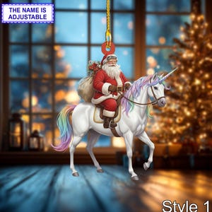 May include: A Christmas ornament featuring Santa Claus riding a white unicorn with a rainbow mane and tail. Santa wears a red suit and carries a sack of gifts. The text "THE NAME IS ADJUSTABLE" is at the top.