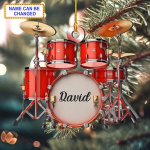 May include: Red drum kit Christmas bauble with the name David on the bass drum.