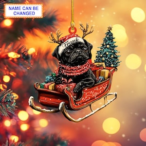 May include: A black pug dog wearing a Santa hat and reindeer antlers sits in a red sleigh with presents. The sleigh is flying through the air with a Christmas tree in the background. The dog's name is "Frank".
