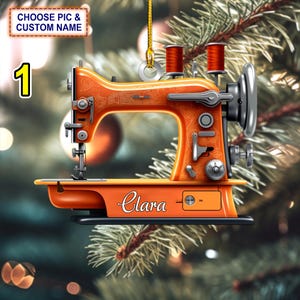 Puede incluir: Adorno de Navidad de máquina de coser naranja con el nombre "Clara" en la base.
