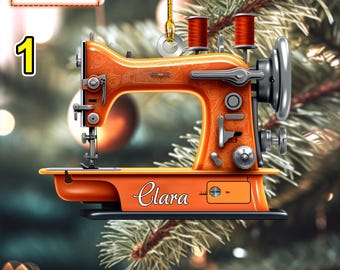 May include: Orange sewing machine Christmas bauble with the name "Clara" on the base.