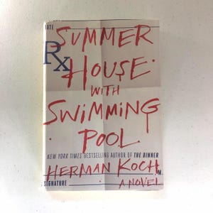 May include: A book cover with the title "Summer House with Swimming Pool" by Herman Koch, a New York Times bestselling author of "The Dinner".